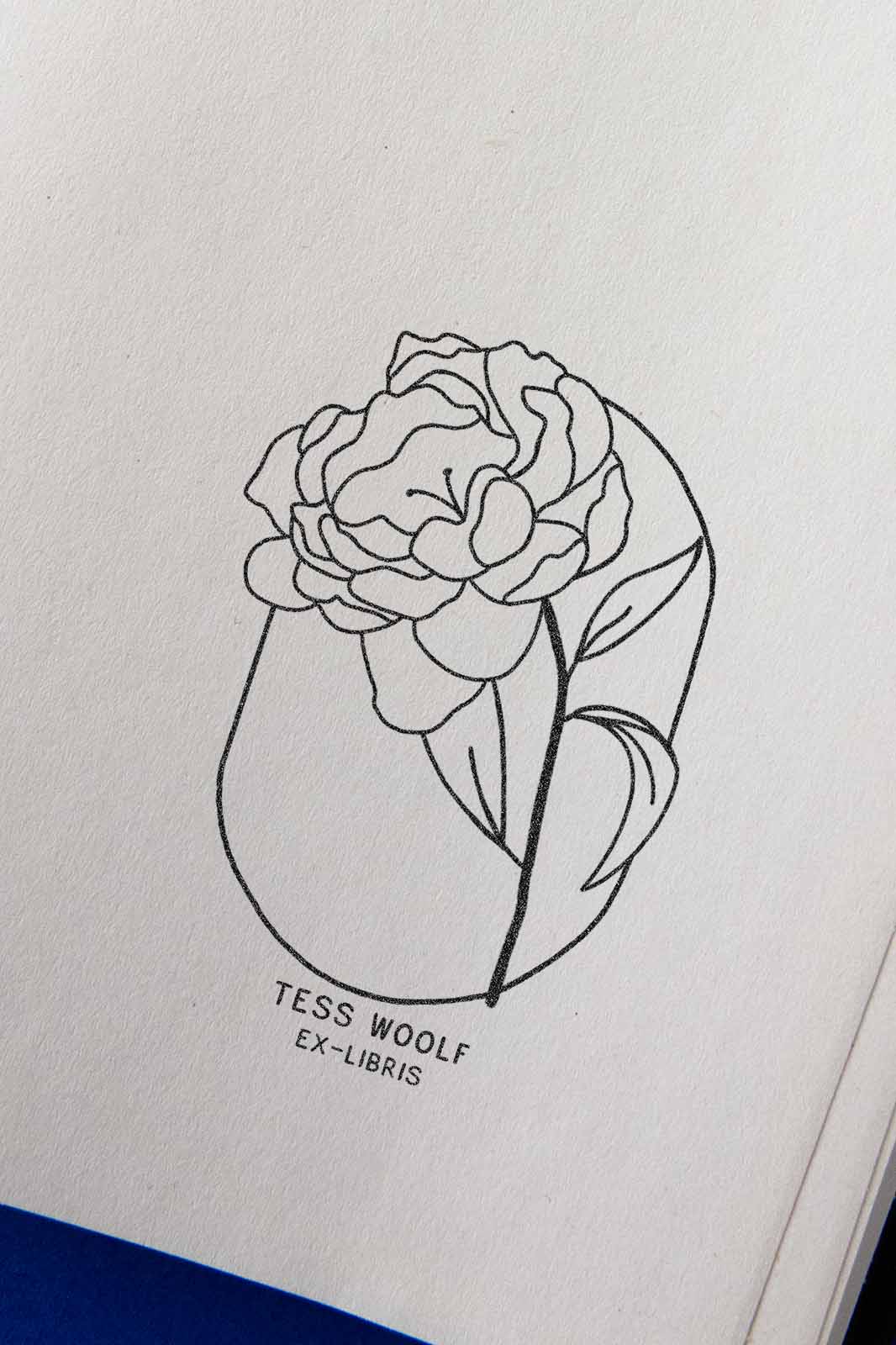 Portadilla de libro estampada con sello exlibris de una flor peonía